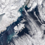 NASA Satellite Captures Mesmerizing Swirling Cloud Formations Off Alaska’s Coast