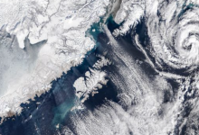 NASA Satellite Captures Mesmerizing Swirling Cloud Formations Off Alaska’s Coast